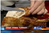 still shot from clip of carving deep-fried turkey