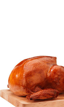 golden color turkey on top of a cutting board that has been deep-fried